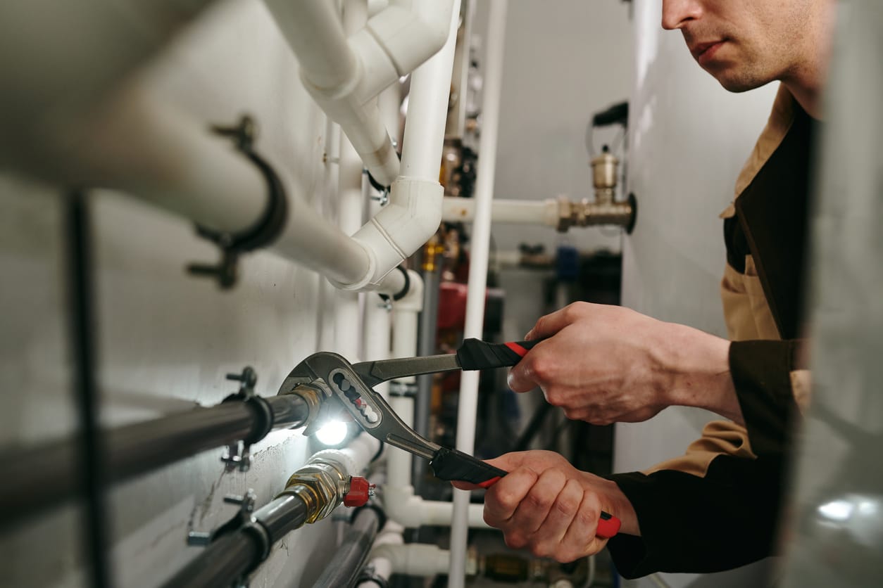 Plumbers maintaining commercial plumbing pipes in Windsor