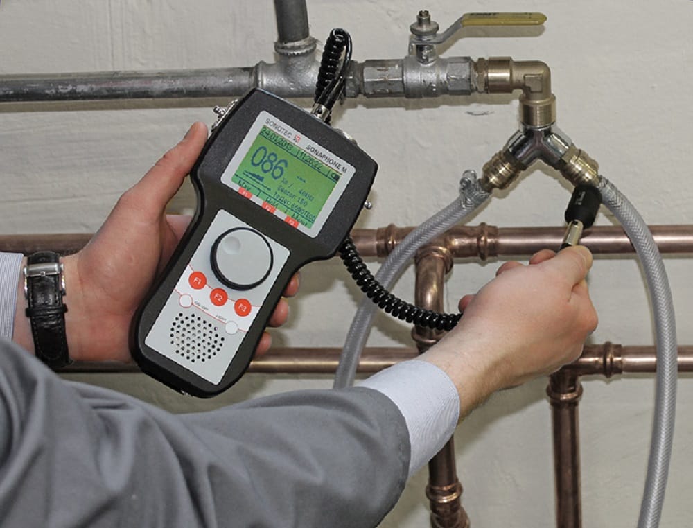 Plumber testing pipes with electronic leak detection equipment in Windsor
